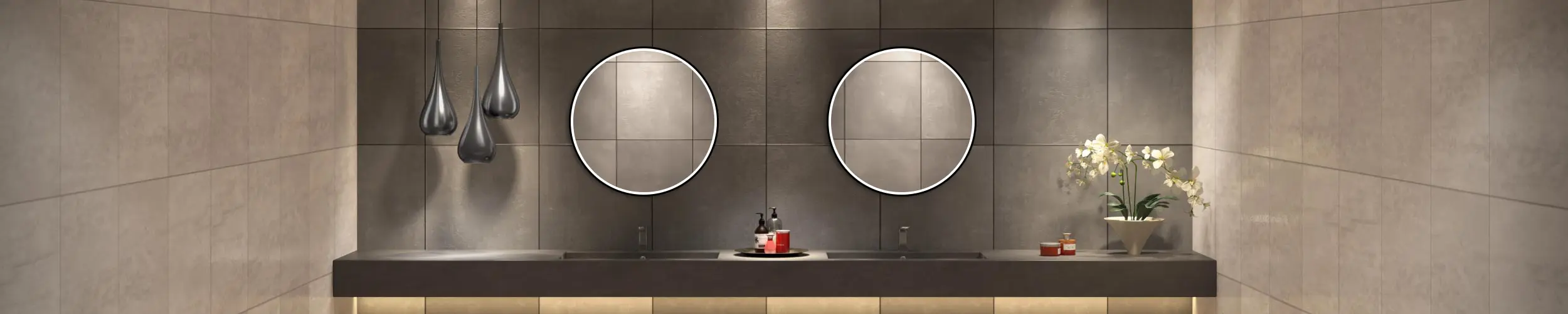 Grand Mirrors Allure inset on a grid patterned concrete wall with two concrete sinks below in Dubai.