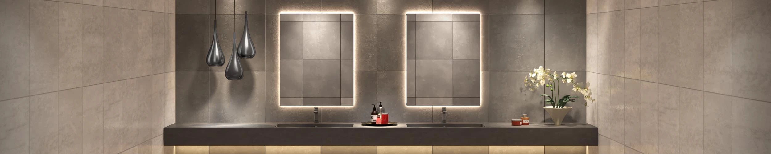 Backlighted mirror mounted on a grid patterned wall above concrete sinks in Bahrain.