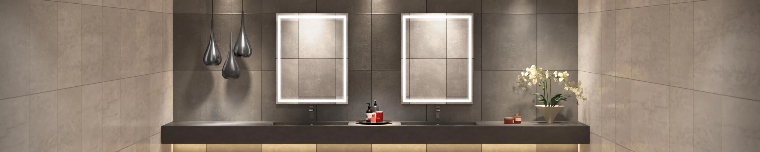 Grid patterned smooth finishing concrete wall with lighted mirrors above the two sinks in Dubai.